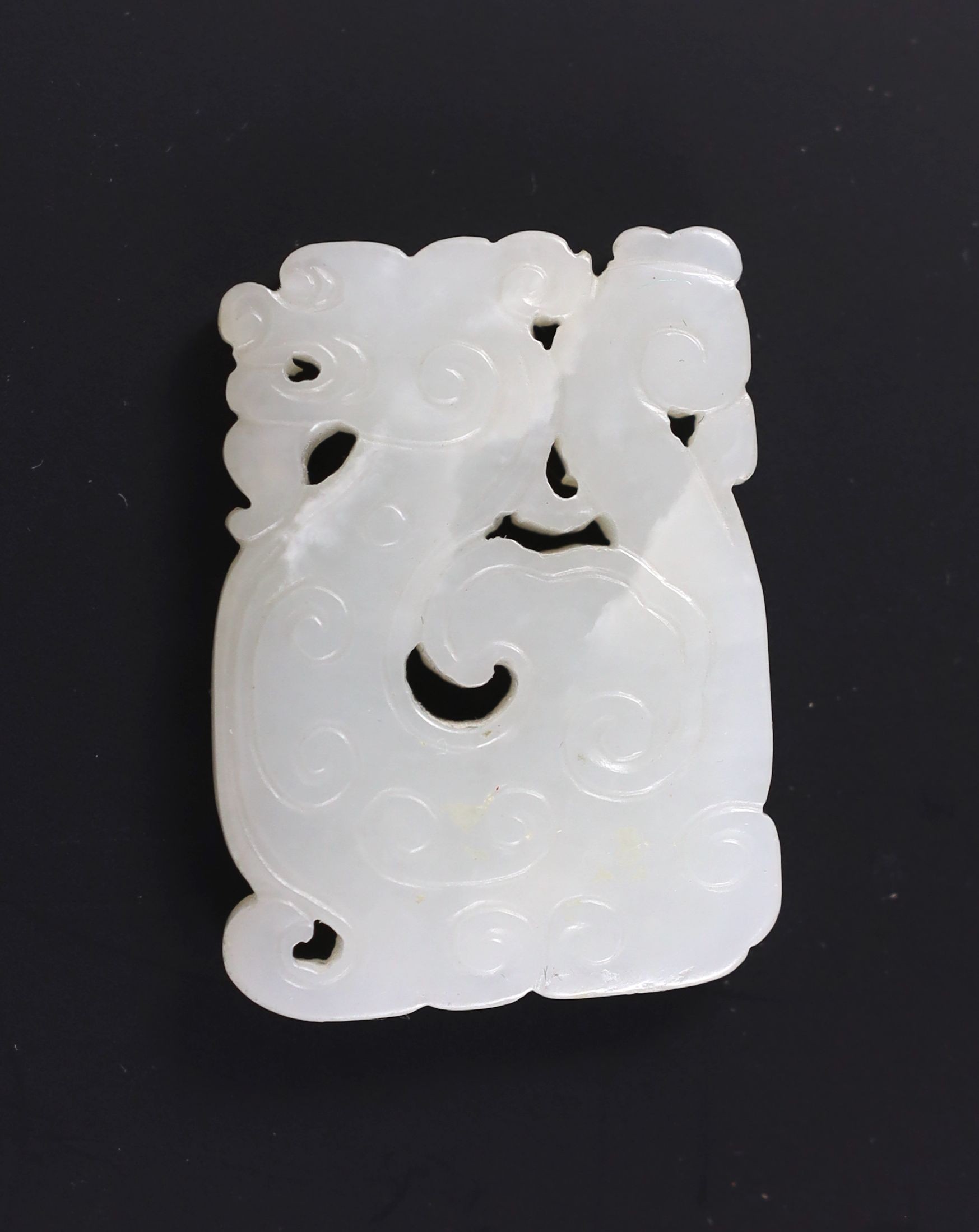 A Chinese white jade plaque, 19th century, 4.9cm, splinter chip, wood stand